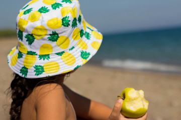 a child in a bright panama hat