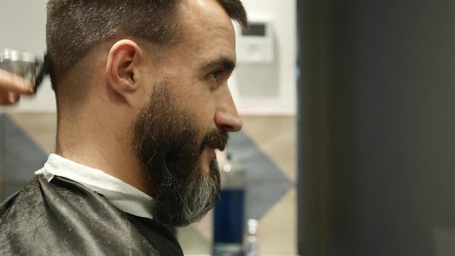 middle age man having a haircut at the barber shop or hairdresser, hipster style, beauty concept 
