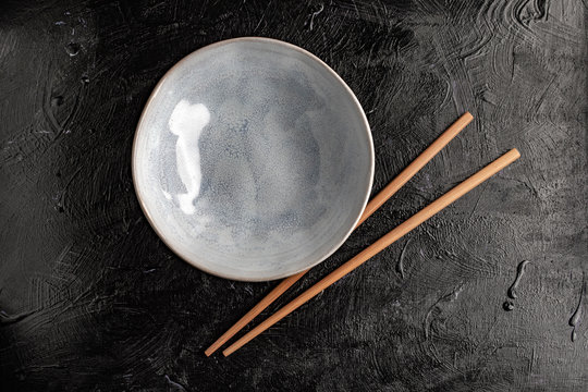 Empty bowl with chopsticks to eat.