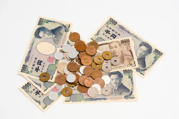 Yen - Japanese money in one thousand yen, ten thousand yen banknotes and various coins isolated on white background with copy space. Horizontal shot.