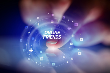 Finger touching tablet with social media icons and ONLINE FRIENDS