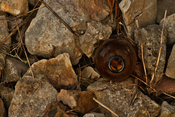 abandoned bottle on rocks