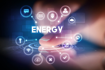 Finger touching tablet with web technology icons and ENERGY inscription, web technology concept