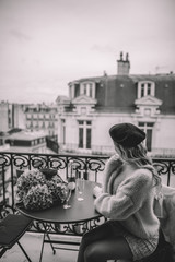 Young woman with blonde hairon Paris balcony 