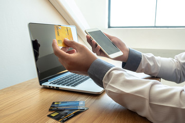 Business people who hold credit cards and smartphones for online shopping and making payments online