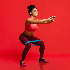 Young woman doing stretching work out with elastic bands