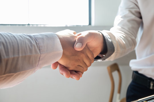 Businessmen shake hands after the competition, showing leadership, followers and business success strategies