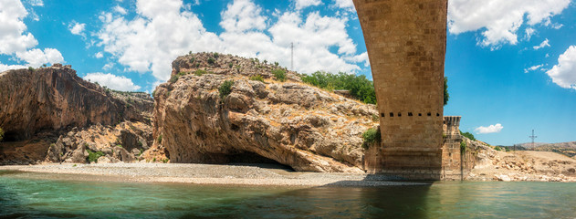Panoramic view of the Severan Bridge, Cendere Koprusu is a late Roman bridge, close to Nemrut Dagi and Adiyaman, Turkey. Roadway flanked by ancient columns of Roman Emperor Lucius Septimius Severus