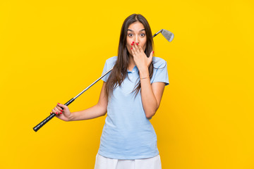 Young golfer woman over isolated yellow wall with surprise facial expression
