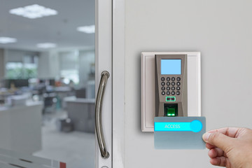 Fingerprint scan machine systems for access interior installed on bricks wall in front of blur...