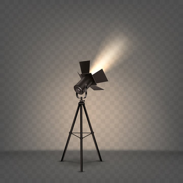 Spotlight realistic vector. Professional photo and video lamp, standing on tripod, stage equipment with warm yellow light on transparent background.
