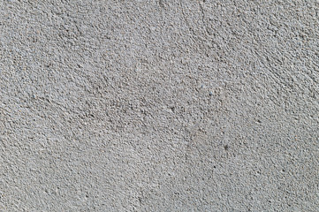 Gray textured cement wall background with fine concrete chips. Construction backgrounds