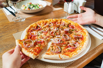 woman eating pizza in pizzeria