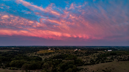 Beautiful sunset and clouds over the rural countryside homes and farms in Nebraska
