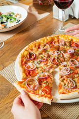 woman eating pizza in pizzeria