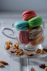 differnt color macaroons in a tea cup