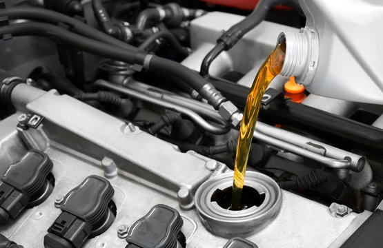 Synthetic motor oil pouring, fresh motor oil