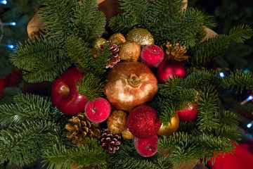 christmas decoration. Apple and pomegranate in sequins. Coniferous branches.  holiday atmosphere.