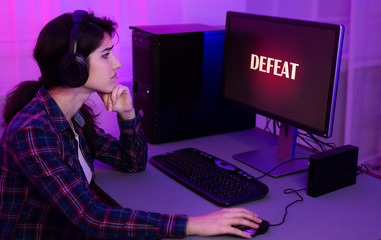 Sad gamer lost game, playing online on computer