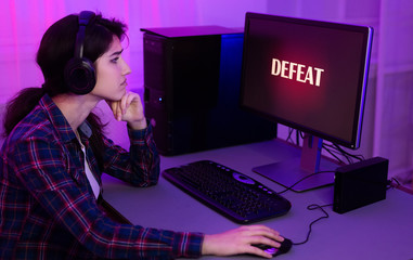 Sad gamer lost game, playing online on computer © Prostock-studio