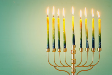 Religion image of jewish holiday Hanukkah background with brass menorah (traditional candelabra) and candles