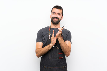 Barber man in an apron applauding after presentation in a conference