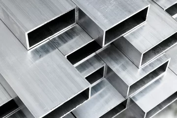 Foto op Aluminium Aluminium profile for windows and doors manufacturing. Structural metal aluminium shapes. Aluminium profiles texture for constructions. Aluminum constructions factory background. © Aleksei