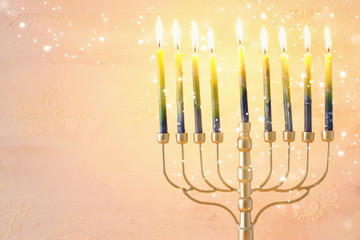 Religion image of jewish holiday Hanukkah background with brass menorah (traditional candelabra) and candles