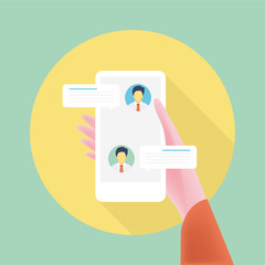Human hand holding smart phone with online chat message notification icon showing on display isolated on green background.