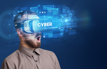 Businessman looking through Virtual Reality glasses with CYBER inscription, innovative security concept