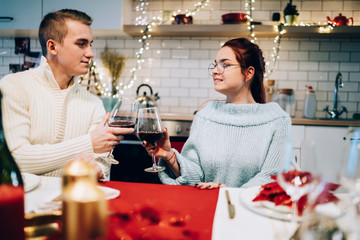 Couple toasting wineglasses on Christmas eve