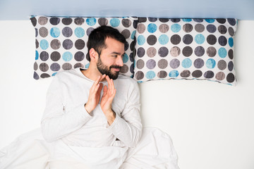 Man in bed in top view scheming something