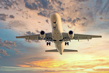 A huge plane shot in flight against the evening sunset sky