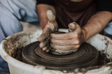 Hands of craftsman artist working on pottery wheel.Selective Focus .