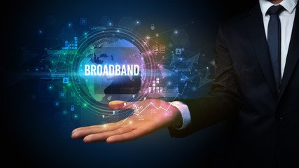 Elegant hand holding BROADBAND inscription, digital technology concept