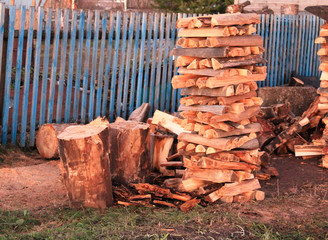 Stacks of firewood, pile of firewood on the grass.