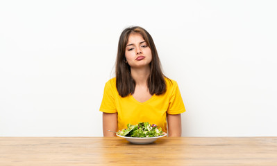 Caucasian girl with salad sad