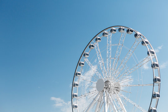 Fragment of a large ferris wheel against the sky.