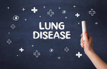 Hand drawing LUNG DISEASE inscription with white chalk on blackboard, medical concept