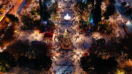 Aerial drone photo of illuminated festive Syntagma square featuring Greek Parliament and Christmas...