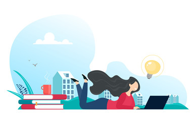 The girl works at the computer while lying, near a stack of books and a hot drink, and behind the silhouette of the city. Vector illustration in cartoon flat style.