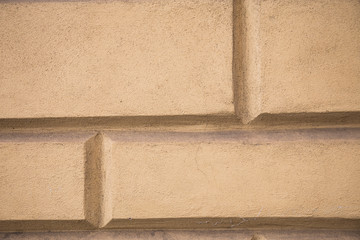 beige empty textured brick wall with copy space