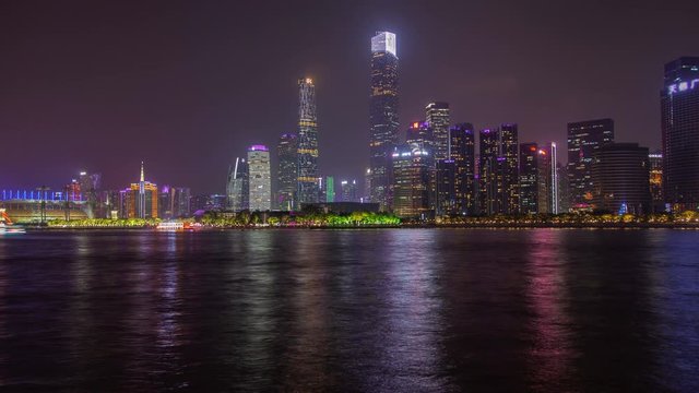 Guangzhou city reflected in Pearl river in China timelapse zoom out