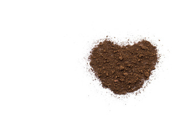 The soil on a white background with a heart shape conveys love and care.