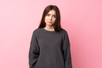Young woman over isolated pink background with sad and depressed expression