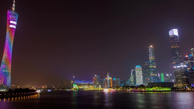 Canton tower near wide calm Pearl river in China timelapse zoom out