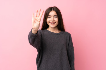 Young woman over isolated pink background happy and counting four with fingers