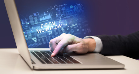 Obraz na płótnie Canvas Businessman working on laptop with DIGITAL WORKFLOW inscription, cyber technology concept