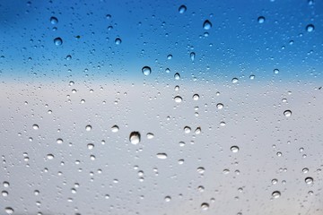 Rain drops with selective focus on transparent glass. Glass surface with water drops. Window with raindrops. water drops on glass. Rainy autumn weather