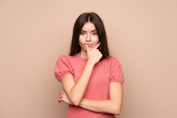 Young woman over isolated background thinking an idea